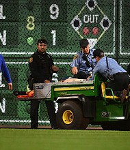 A fan is carted off the field after falling from the stands at PNC Park.
Mandatory Credit: