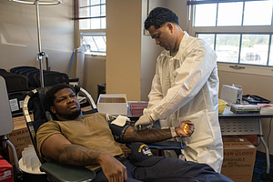 U.S. Army Staff Sgt. Marcos Flores, right, from San Bernardino, California, draws blood from Aviation Boatswain’s Mate (Aircraft Handling) 3rd Class Camriyon Smith, from Houston, during a blood drive in the Fleet Logistics Center building at Naval Base Kitsap-Bremerton, Washington, May 6, 2025. Ronald Reagan is undergoing scheduled maintenance at Puget Sound Naval Shipyard and Intermediate Maintenance Facility while remaining a combat-ready force dedicated to protecting and defending the United States. (U.S. Navy photo by Aviation Electronics Technician 3rd Class Benjamin Hurner)