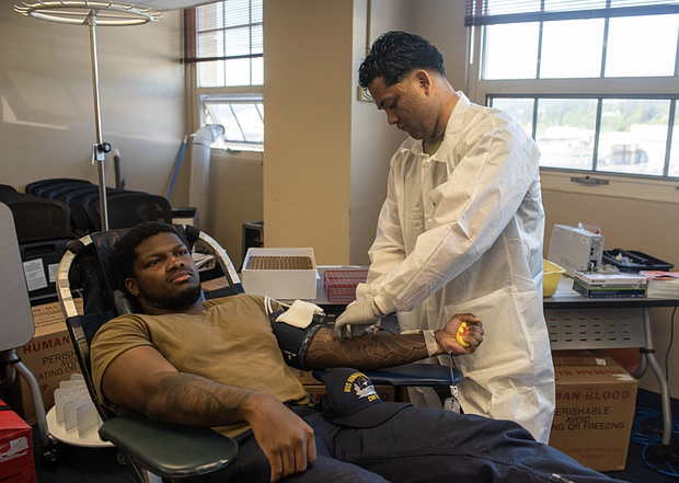 U.S. Army Staff Sgt. Marcos Flores, right, from San Bernardino, California, draws blood from Aviation Boatswain’s Mate (Aircraft Handling) 3rd Class Camriyon Smith, from Houston, during a blood drive in the Fleet Logistics Center building at Naval Base Kitsap-Bremerton, Washington, May 6, 2025. Ronald Reagan is undergoing scheduled maintenance at Puget Sound Naval Shipyard and Intermediate Maintenance Facility while remaining a combat-ready force dedicated to protecting and defending the United States. (U.S. Navy photo by Aviation Electronics Technician 3rd Class Benjamin Hurner)