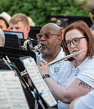 Members of the Richmond Concert Band play to an outdoor crowd during a recent concert at Agecroft Hall and Gardens.
