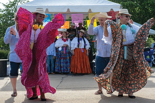 Jacqueline Anthony and Xiomara Holt of the Panamanian Traditional Dance Group, a non-profit dedicated to preserving and promoting the folkloric dance traditions of Panama, performed at the ¿Qué Pasa? Festival on Brown’s Island, May 3.