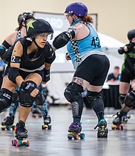Brianna “Killer B” Walker (#612), a member of Richmond’s roller derby team, the River City River Rats, helps lead her team to a dominating 269-55 victory over a Greensboro team in
the first matchup of a Roller Derby Double Header at the Greater Richmond Convention Center on Saturday, April 26.