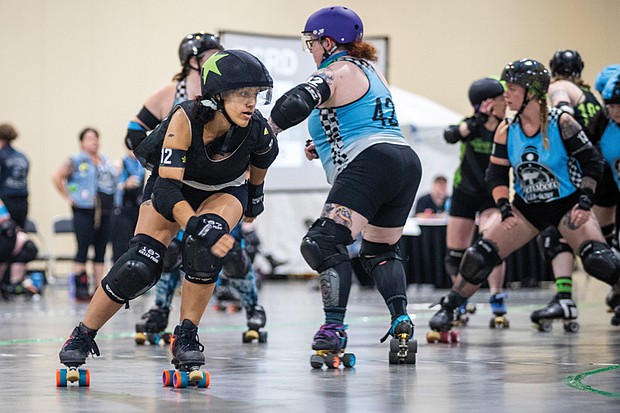 Brianna “Killer B” Walker (#612), a member of Richmond’s roller derby team, the River City River Rats, helps lead her team to a dominating 269-55 victory over a Greensboro team in
the first matchup of a Roller Derby Double Header at the Greater Richmond Convention Center on Saturday, April 26.