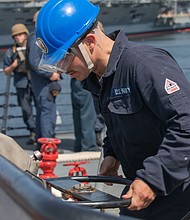YOKOSUKA, Japan (May 7, 2025) Seaman Carlos Figueroa, from Houston, Texas, releases the brake on the anchor chain on the fo’c’sle of the Arleigh Burke-class guided missile destroyer USS Benfold (DDG 65) during special sea and anchor detail while departing Yokosuka Japan, May 7. Benfold is forward deployed and assigned to Destroyer Squadron (DESRON) 15, the Navy’s Largest DESRON and U.S. 7th Fleet’s principal surface force. (U.S. Navy Photo by Mass Communication Specialist 2nd Class Monica Walker.)