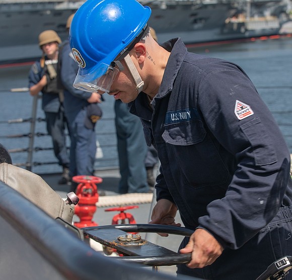 Houston, TX — In the vast blue expanse of the Philippine Sea, a hometown hero stands tall aboard one of …