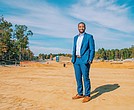 Jovan Burton, executive director of the Partnership for Housing Affordability, stands at
the Parkside Townes development site in Sandston.