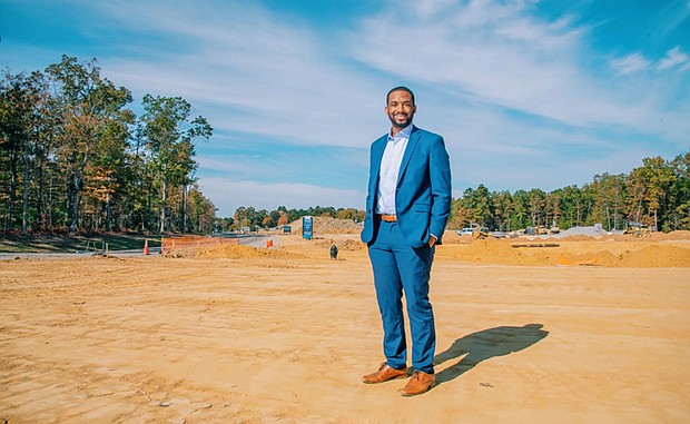 Jovan Burton, executive director of the Partnership for Housing Affordability, stands at
the Parkside Townes development site in Sandston.