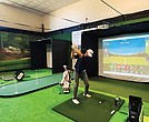 A golfer practices on one of the new simulators at Virginia State University’s Fitness/Wellness Center. The equipment was donated by the PGA to help expand access and diversity in the golf industry.