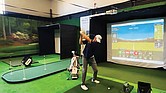 A golfer practices on one of the new simulators at Virginia State University’s Fitness/Wellness Center. The equipment was donated by the PGA to help expand access and diversity in the golf industry.