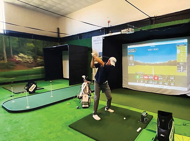 A golfer practices on one of the new simulators at Virginia State University’s Fitness/Wellness Center. The equipment was donated by the PGA to help expand access and diversity in the golf industry.