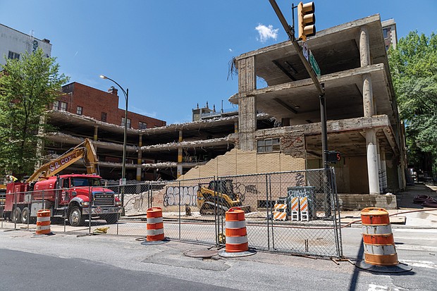 Demolition is underway at a crumbling parking garage at 509 E. Franklin St., forcing the closure of a nearby sidewalk and parking lane.