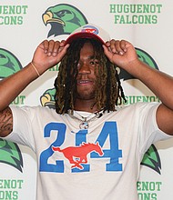 Huguenot High School linebacker Markel Dabney dons an SMU cap after committing to Southern Methodist University. Dabney is the first linebacker to pledge to SMU’s 2026 recruiting class.