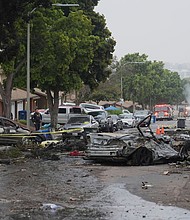 Several cars ignited after a small plane crashed into a San Diego neighborhood early on May 22.
Mandatory Credit:	Gregory Bull/AP via CNN Newsource