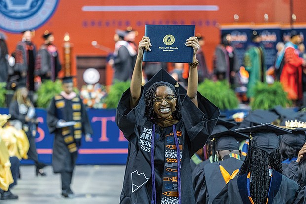 Melana Jacks raises her diploma over her head after graduating from the College of Humanities and Social Sciences at Virginia State University’s spring commencement ceremony May 17 at the VSU Multi-Purpose Center. The university held multiple ceremonies over the weekend to honor graduates from various colleges and programs.