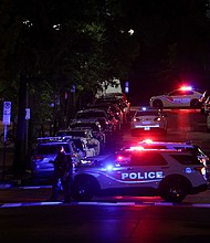 Police officers work at the site of the shooting.
Mandatory Credit:	Jonathan Ernst/Reuters via CNN Newsource