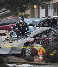 Authorities work the scene where a small plane crashed into a San Diego neighborhood early Thursday.
Mandatory Credit:	Gregory Bull/AP via CNN Newsource