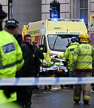 Officers carry away injured people following the collision.
Mandatory Credit:	Paul Ellis/AFP/Getty Images via CNN Newsource