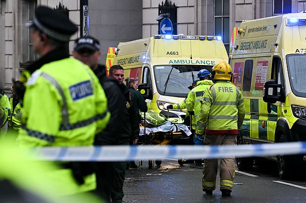 Officers carry away injured people following the collision.
Mandatory Credit:	Paul Ellis/AFP/Getty Images via CNN Newsource