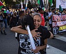 People embrace while attending a march remembering George Floyd on Wednesday, May 21, in Los Angeles.