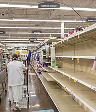 Shoppers arrive at the water aisle of the Kroger on Lombardy Street on Tuesday to find empty shelves following a boil water advisory issued by the City of Richmond.