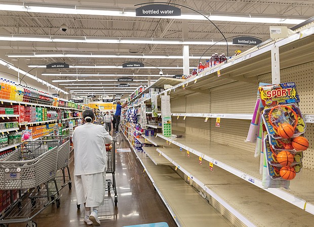 Shoppers arrive at the water aisle of the Kroger on Lombardy Street on Tuesday to find empty shelves following a boil water advisory issued by the City of Richmond.