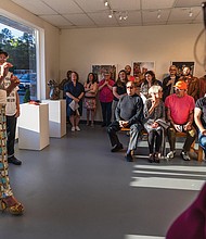 Guests listen to Pierce talk during the opening. According to the exhibition’s press release, the featured artists “boldly reclaim and redefine” concepts of beauty and glamour through a diverse range of expressions.