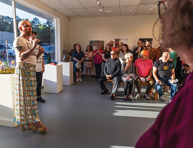 Guests listen to Pierce talk during the opening. According to the exhibition’s press release, the featured artists “boldly reclaim and redefine” concepts of beauty and glamour through a diverse range of expressions.