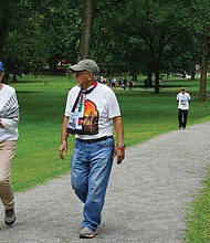 William and Robin Allman walk and talk with Team Hind organizer Adeeb Abed along the Vita Course Trail during Saturday’s Gaza solidarity walkathon in Byrd Park. The event raised funds for mental health support for Palestinian children.