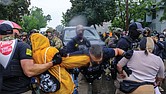 Protesters confront ICE, ATF and FBI officers as federal agents conduct an operation June 3 in Minneapolis.