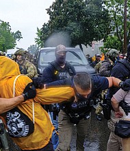 Protesters confront ICE, ATF and FBI officers as federal agents conduct an operation June 3 in Minneapolis.