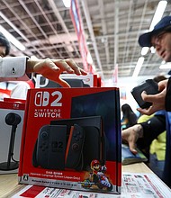 A man buys a Nintendo Switch 2 gaming device as Nintendo starts selling the new consoles globally, at an electronics store in Tokyo, Japan, on June 5.
Mandatory Credit:	Issei Kato/Reuters via CNN Newsource