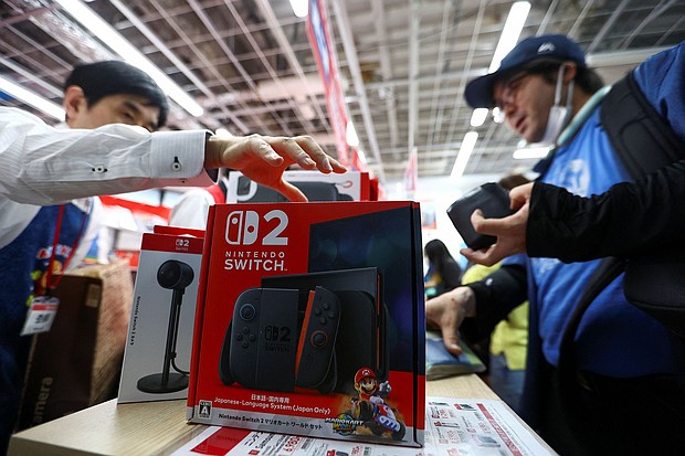 A man buys a Nintendo Switch 2 gaming device as Nintendo starts selling the new consoles globally, at an electronics store in Tokyo, Japan, on June 5.
Mandatory Credit:	Issei Kato/Reuters via CNN Newsource