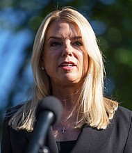Attorney General Pam Bondi speaks to reporters at the White House on May 7.  The Justice Department filed a lawsuit Wednesday alleging that the state of Texas is discriminating against out-of-state college students.
Mandatory Credit:	Mark Schiefelbein/AP via CNN Newsource