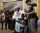 Suvya Carroll, seated, and others pray in the U.S. Capitol Rotunda, Monday, June 2, 2025, in Washington.