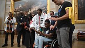 Suvya Carroll, seated, and others pray in the U.S. Capitol Rotunda, Monday, June 2, 2025, in Washington.