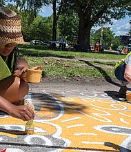 Richmond residents Alexis Fryar and Kathryn Settle contribute to a community mural at the
intersection of Hermitage and Laburnum during a volunteer paint day. The collaborative artwork
is part of a traffic calming initiative aimed at enhancing pedestrian and cyclist safety in the area
surrounding Linwood Holton Elementary School.