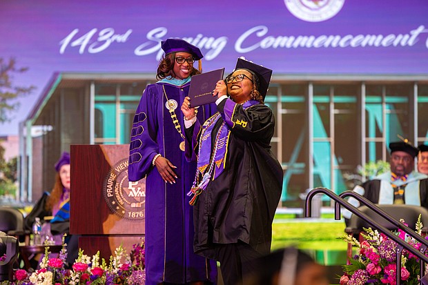 Ariel Smith receiving her degree from PVAMU President Tomikia LeGrande, Ed. D.