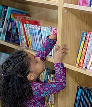 A student browses available books inside the Henrico County Public Schools’ Mobile Resource Center.