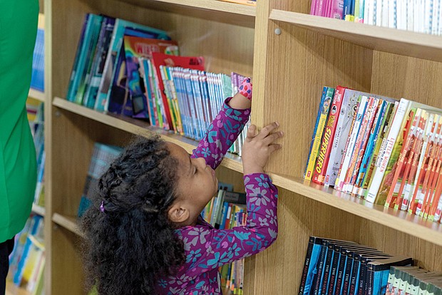 A student browses available books inside the Henrico County Public Schools’ Mobile Resource Center.