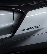 New Corvette ZR1X badge on 2026 Corvette ZR1X in Blade Silver Metallic. Preproduction model shown, actual production model may vary.