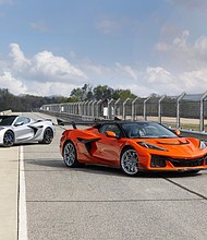Front 3/4 view of Blade Silver Corvette ZR1X and Sebring Orange Tintcoat Corvette ZR1X Convertible with ZTK Performance Package. Preproduction model shown, actual production model may vary.