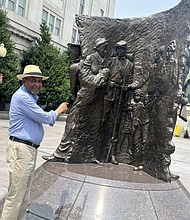 Dr. Frank Smith, founder and executive director of the African American Civil War Memorial and Museum, stands next to the U Street Memorial in Washington, DC where the Juneteenth celebration will take place under a big tent starting at 11 am on June 19th.