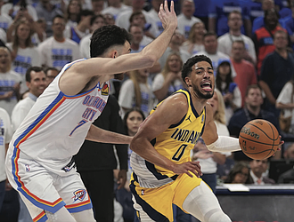 Indiana Pacers guard Tyrese Haliburton (0) drives past Oklahoma City Thunder forward Chet Holmgren (7) during the second half of Game 5 of the NBA Finals basketball series, Monday, June 16, 2025, in Oklahoma City.