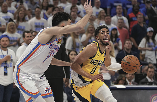 Indiana Pacers guard Tyrese Haliburton (0) drives past Oklahoma City Thunder forward Chet Holmgren (7) during the second half of Game 5 of the NBA Finals basketball series, Monday, June 16, 2025, in Oklahoma City.