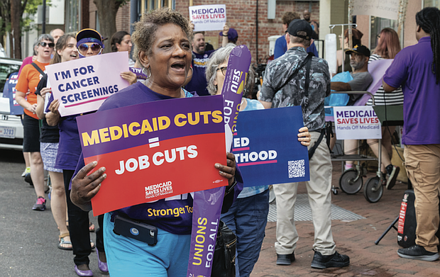 Tina Buskey, a public school worker joins demonstrators that protested Sears’ silence on proposed Medicaid cuts. Buskey, who has dealt with severe illnesses, said, “Without Medicaid, I would be dead.”
