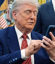 President Donald Trump silences his mobile phone.
Mandatory Credit:	Evan Vucci/AP/File via CNN Newsource
