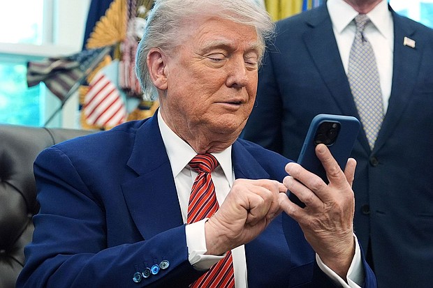 President Donald Trump silences his mobile phone.
Mandatory Credit:	Evan Vucci/AP/File via CNN Newsource