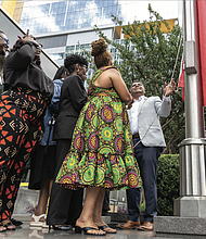 Mayor Danny Avula, City Council President Cynthia Newbille, Black History Museum Executive Director Shakia Gullette Warren, Elegba Folklore Society President Janine Bell and others take part in a Juneteenth flag-raising ceremony at Richmond City Hall on June 17.
