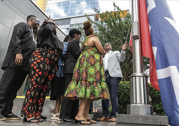 Mayor Danny Avula, City Council President Cynthia Newbille, Black History Museum Executive Director Shakia Gullette Warren, Elegba Folklore Society President Janine Bell and others take part in a Juneteenth flag-raising ceremony at Richmond City Hall on June 17.