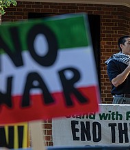 Noah Irikawa speaks during a rally Wednesday, June 18, in Monroe Park to oppose U.S. military involvement with Iran and to protest violence in Palestine.